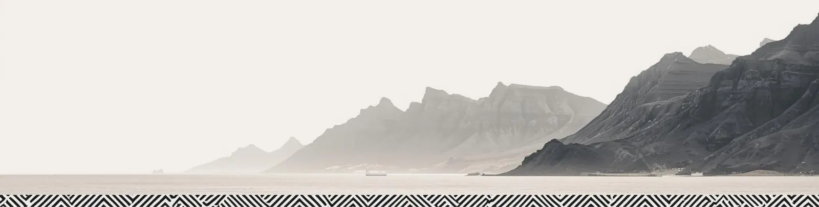 Coastal mountains above a still bay, with a geometric RAHN pattern band along the shoreline